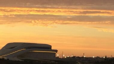 a plane is flying in the sky at sunset